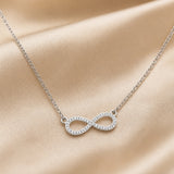 Necklace in white gold with a pendant infinity shape and zirconia.
